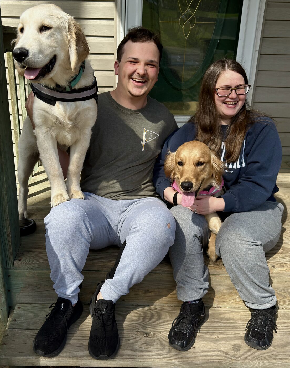 Caleb and Maegan Wright at home with their two dogs